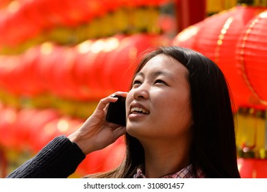 Chinese Woman Talking On Cell Phone During Chinese New Year