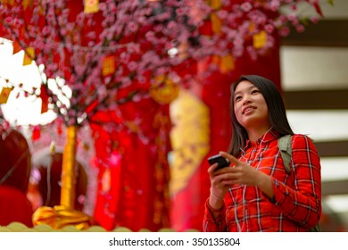 Chinese Woman Talking On Cell Phone During Chinese New Year