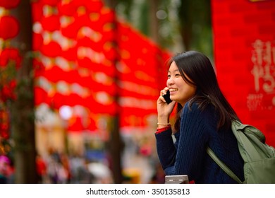 Chinese Woman Talking On Cell Phone During Chinese New Year