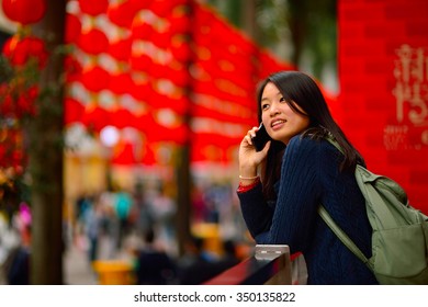 Chinese Woman Talking On Cell Phone During Chinese New Year