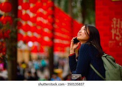 Chinese Woman Talking On Cell Phone During Chinese New Year