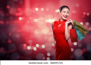 Chinese Woman Wearing Cheongsam Hold Shopping Bag. Happy Chinese New Year