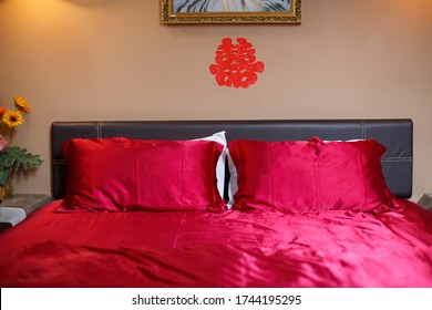 Chinese Wording Double Happiness Sticker At The Head Of The Bed With Red Bedsheet