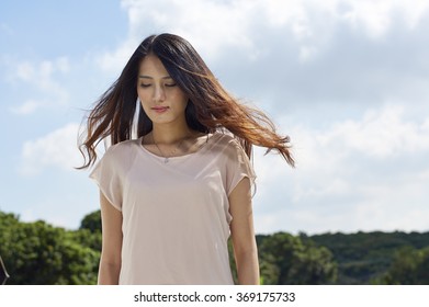 Chinese young beauty standing in wind 