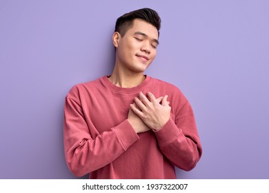 Chinese Young Male Expressing Gratitude, Holding Hands On Chest