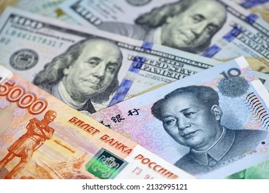 Chinese Yuan, Russian Rubles And US Dollars Banknotes. Concept Of Trade War Between The China And USA, Sanctions Against Russia