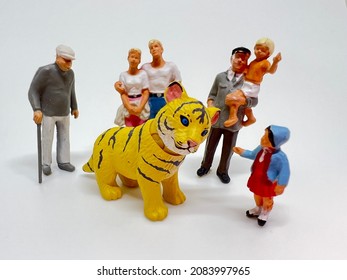 Chinese Zodiac Sign Year of Tiger.Happy Chinese New Year, Year of the Tiger. A miniature of a tiger and a group of people on a white background.