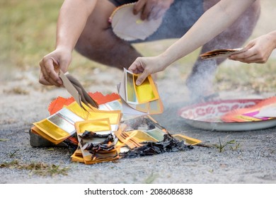Chinses New Year. Burned gold money paper. Burning the silver and gold fake money paper for Chinese dead people ancestors. joss paper or gold money paper burning in Chinese new year festival.