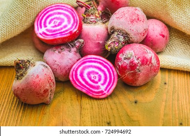 Chioggia striped or candy stripe beet whole and sliced in burlap sack on old rustic wooden table, selective focus - Powered by Shutterstock