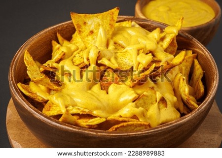 Chip in cheese sauce, close up Nachos.