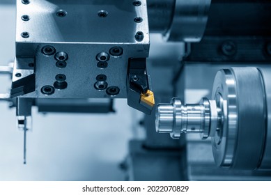 The chip insert cutting tool of CNC lathe machine cutting the metal shaft parts . The hi-technology metal working processing by CNC turning machine .