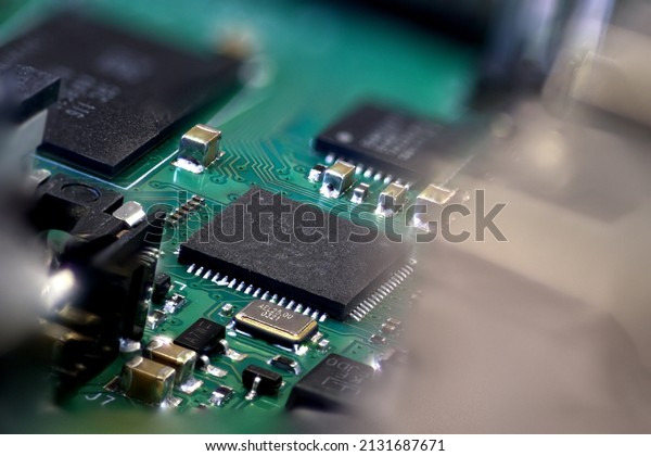 Chip on\
PCB shot on macro. Suitable for chip shortage articles. There is\
some crystals, controllers and other small\
parts
