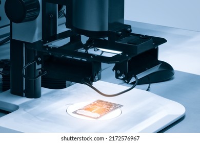 Chip Testing Equipment. Manufacturing Of Microchips. A Close-up Study Of A Test Sample Of A Transistor Chip Under A Microscope In The Laboratory. Automation Of Production.