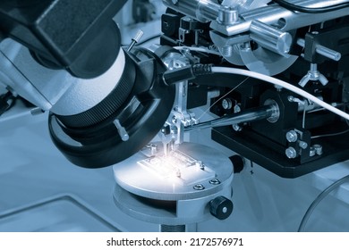 Chip Testing Equipment. Manufacturing Of Microchips. A Close-up Study Of A Test Sample Of A Transistor Chip Under A Microscope In The Laboratory. Automation Of Production.