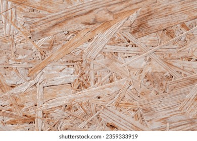 Chipboard plywood, surface close-up, uniform texture background, glued splinters - Shutterstock ID 2359333919