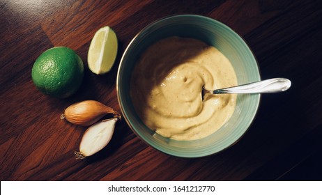 Chipotle Mayo In A Green Bowl With Essential Ingredients On The Side