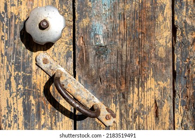 Chipped Beige Paint And Rust On An Old Door Knob On A Very Dirty Door Of An Abandoned House.