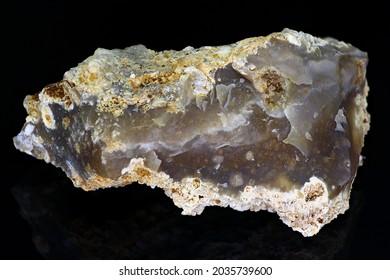 Chipped bluish-gray chalcedony on a black background close up, mineralogical sample. Deposit Russia - Shutterstock ID 2035739600