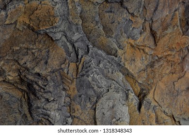 Chipped And Broken Shale Rock Face With Layers Of Blue And Orange Stone Closeup Abstract Texture Background. 