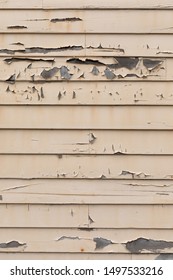 Chipped and peeling paint on exterior wood siding, in an architectural background