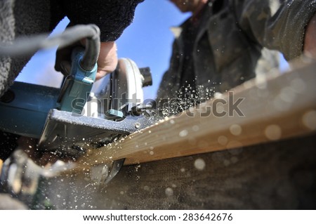 chips from a circular saw. Two men carpenters