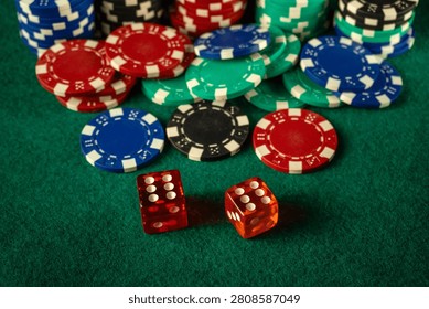 Chips of different colors are spread out on a green felt table with two dice showing numbers. The scene suggests a game setup where players can place bets.