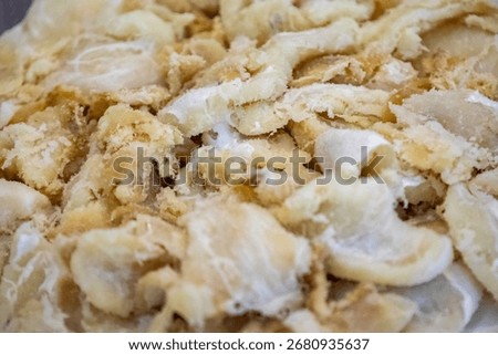 chips of gadus macrocephalus cod fillet, salted and dried, on a round white plate