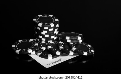 Chips and joker card on the black table in the casino. Fortune or success in the game of poker - Shutterstock ID 2095014412