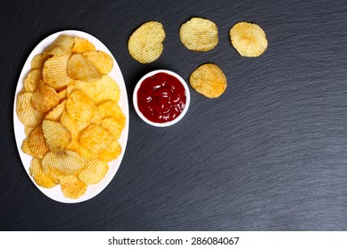 Chips And Ketchup On A Black Background