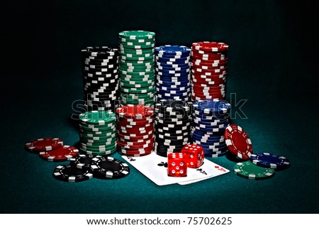 chips for poker with pair of aces and dice