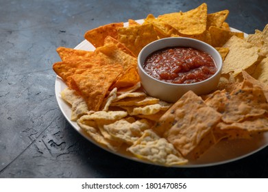 Chips and various snacks for beer with salsa on a blue background, rest and gatherings with the company