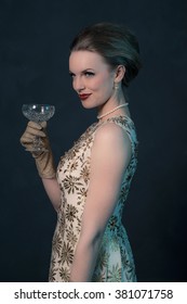 Chique Vintage 50s Fashion Woman In Gold Dress Holding Champagne Glass.