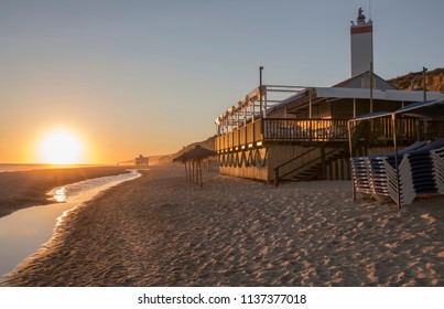 Chiringuito or beach bar at Costa de la Luz seashore, Matalascanas, Huelva. Sunset - Powered by Shutterstock