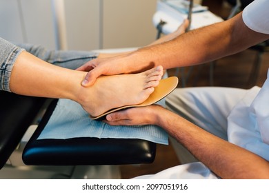 Chiropodist Fitting An Orthopedic Foot Insole To A Patient.