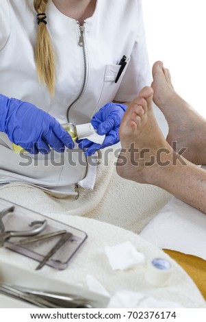 chiropodist gives a medical treatment at home foot care