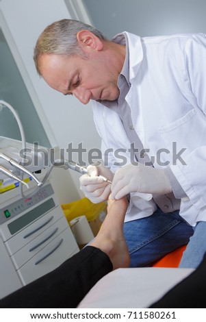 chiropodists removes dry skin of heel of the foot