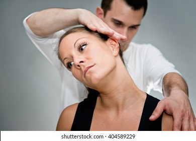 Chiropractic Adjustment - Chriopractor Working On Patient's Neck