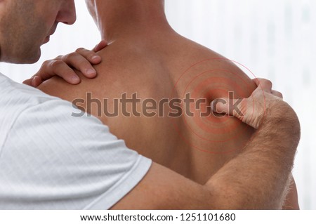 Chiropractic back adjustment. Acupressure Osteopathy, sport injury rehabilitation concept. Male patient suffering from back pain and physical therapist