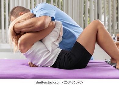 Chiropractic back pain treatment, with chiropractor performing an upper back adjustment on a patient lying on a therapy table, focusing on spinal alignment, pain relief, and improving mobility   - Powered by Shutterstock