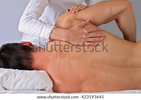 Chiropractic, osteopathy, manual therapy.Therapist  doing healing treatment on man's back. Alternative medicine, pain relief concept