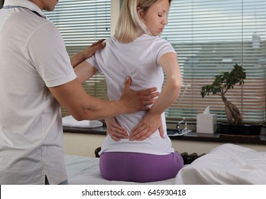 Chiropractic, Osteopathy, Physiotherapy, Sport Injury Rehabilitation. Alternative Medicine, Pain Relief Concept. Woman Patient Suffering From Back Pain During Medical Exam.