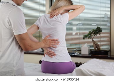 Chiropractic, Osteopathy, Physiotherapy, Sport Injury Rehabilitation. Alternative Medicine, Pain Relief Concept. Woman Patient Suffering From Back Pain During Medical Exam.