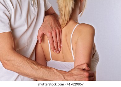 Chiropractic, Osteopathy. Therapist  Doing Healing Treatment On Woman's Back . Alternative Medicine, Pain Relief Concept