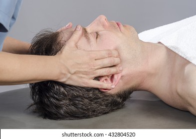 Chiropractor Assessing The Muscles On A Jaw