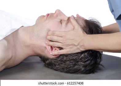 Chiropractor Assessing The Muscles On A Jaw