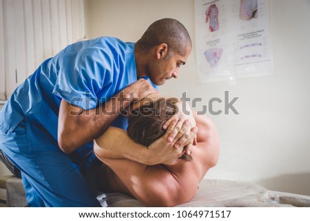 Chiropractor doing adjustment on female patient due to neck pain
