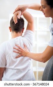 Chiropractor Doing Adjustment On Male Patient