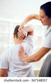 Chiropractor Doing Adjustment On Male Patient