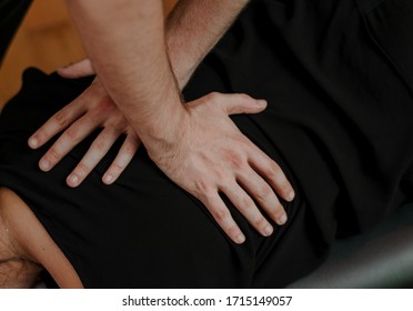 Chiropractor Massaging Back With Hands