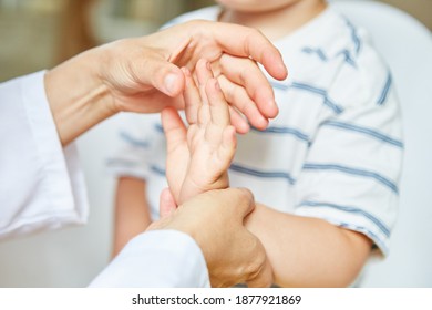 Chiropractor or osteopath treats hand of child with sprain on wrist - Powered by Shutterstock